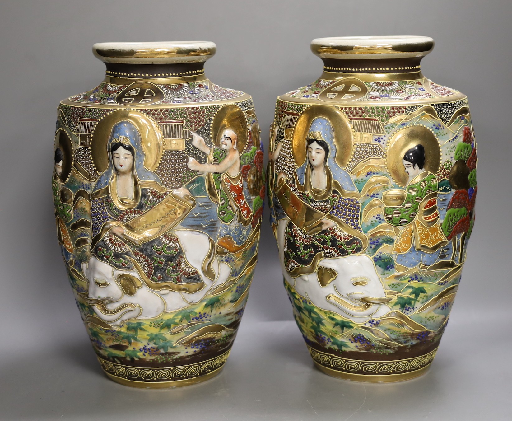 A pair of Japanese moulded and moriage decorated vases, 31cms